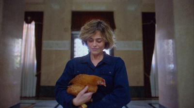 a woman holding a chicken in her hands