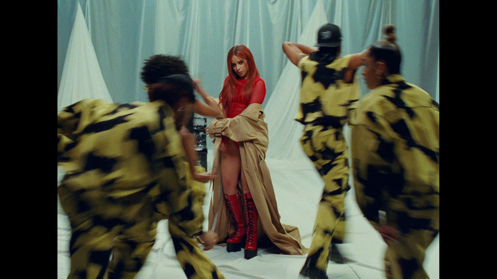 a group of people dressed in costumes dancing