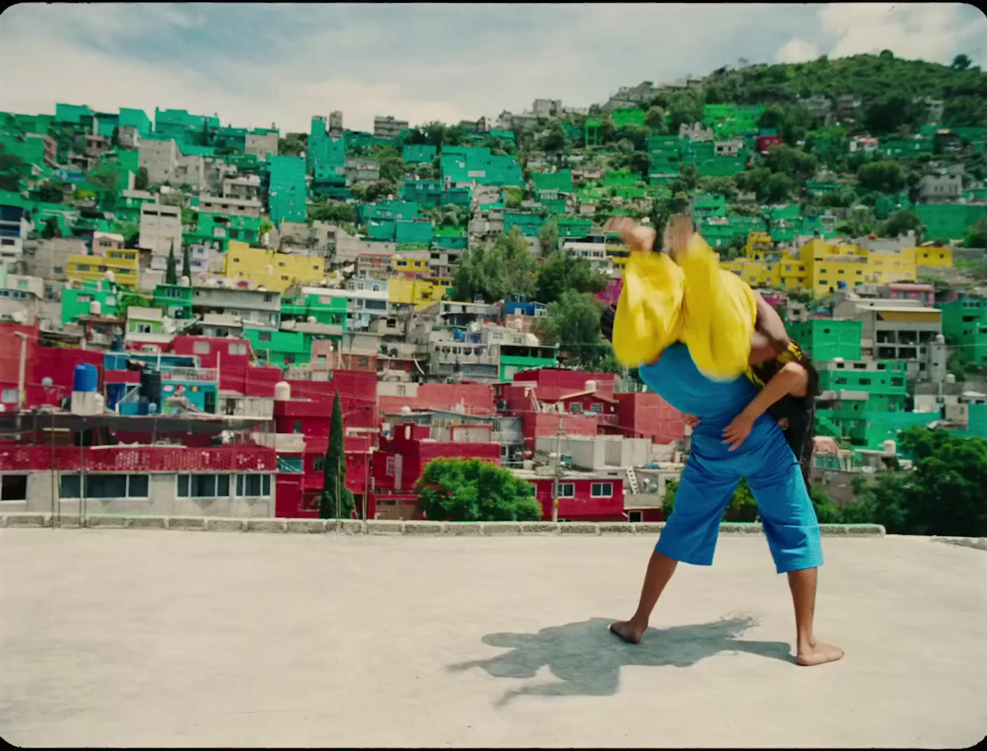 a man doing a handstand in front of a city