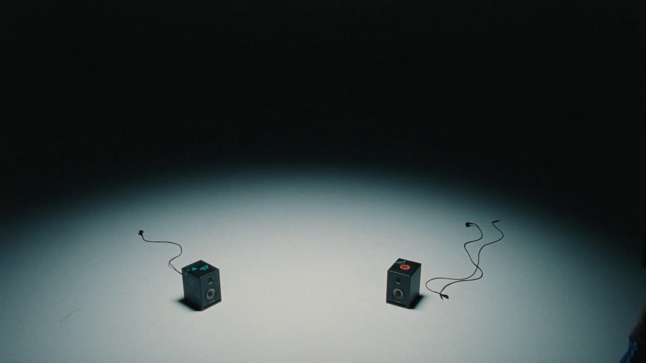 a couple of speakers sitting on top of a table