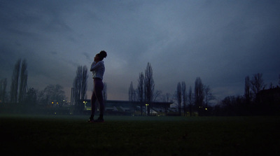 a person standing in a field at night