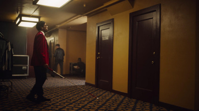 a man is standing in a hallway with a mop