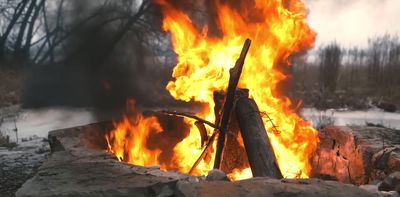 a fire blazing in the middle of a field