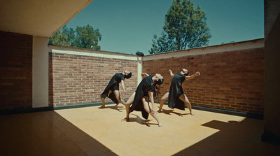 a group of people standing on top of a wooden floor