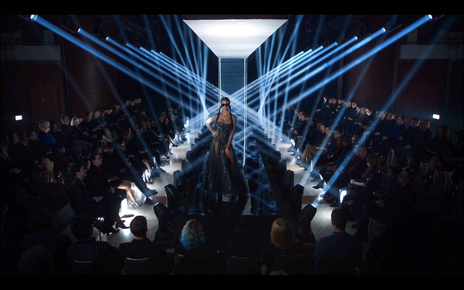 a woman standing on a stage in front of a crowd