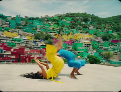 two people doing a handstand in front of a mountain