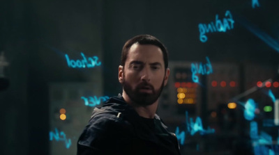 a man standing in front of a wall with writing on it