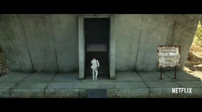 a person standing in a doorway of a building