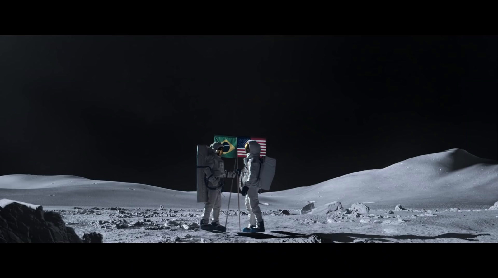 a couple of people standing on top of a snow covered field