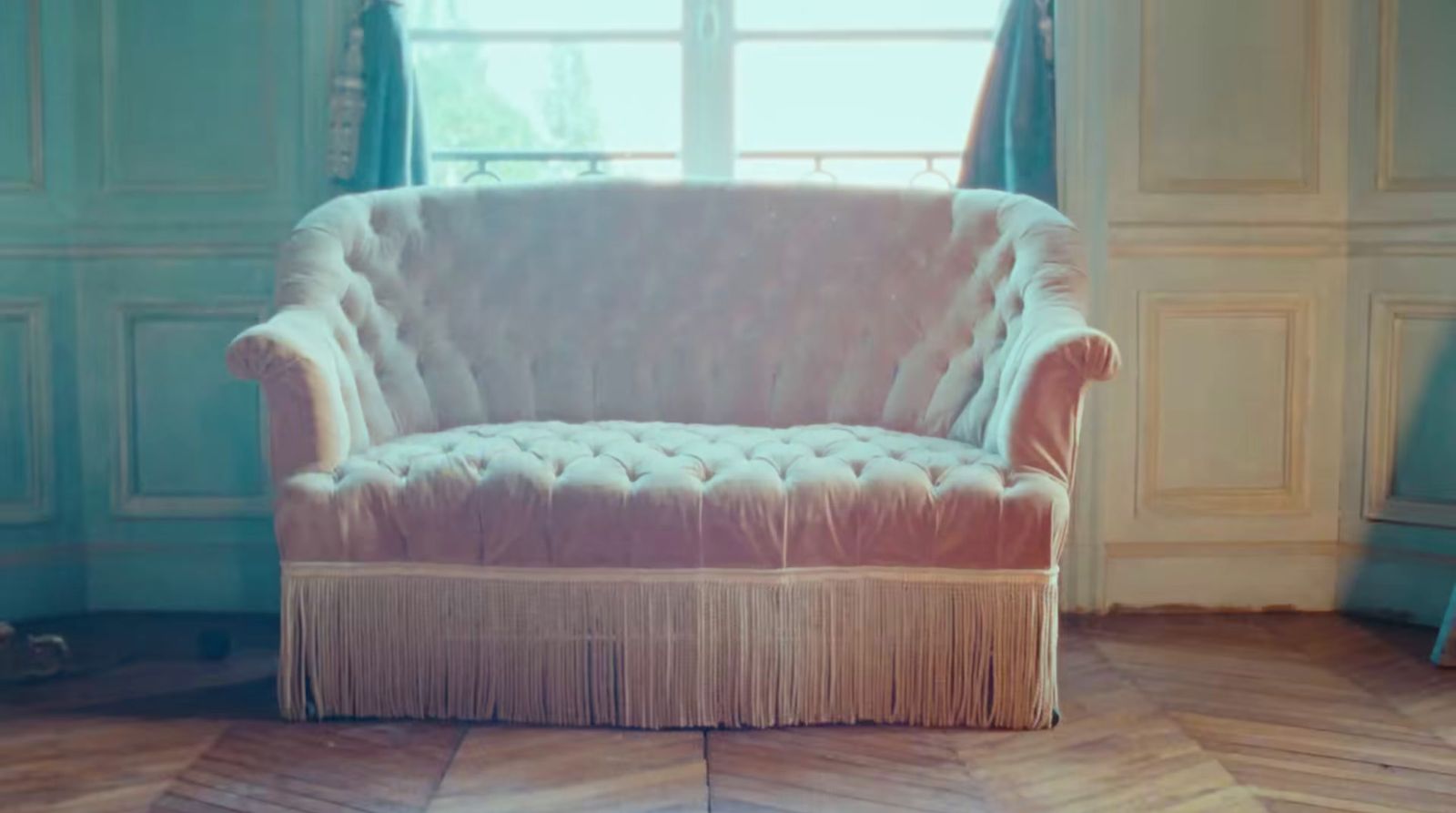 a white chair sitting in a room next to a window