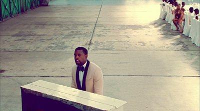 a man in a tuxedo standing in front of a podium