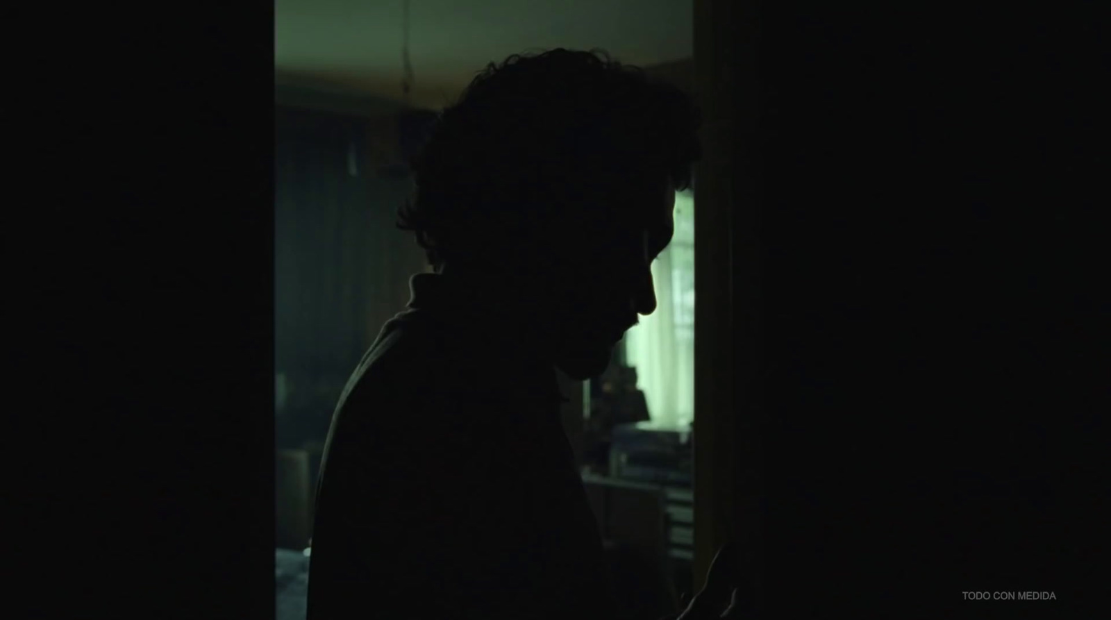 a silhouette of a person in a dark room