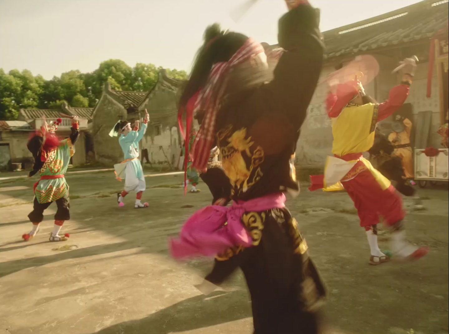 a group of people dancing in a courtyard