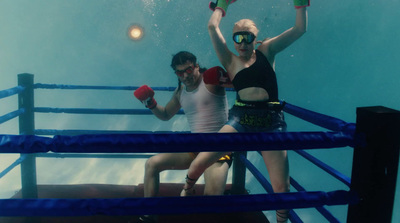 a couple of women standing next to each other under water