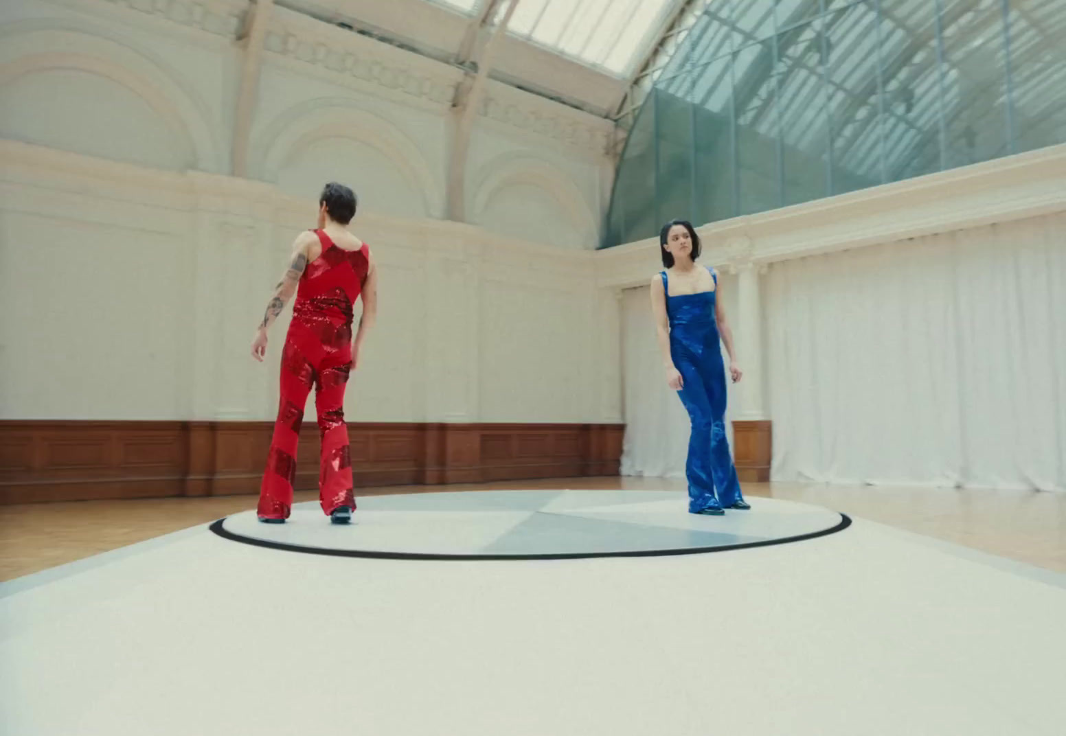 a couple of women standing on top of a white floor