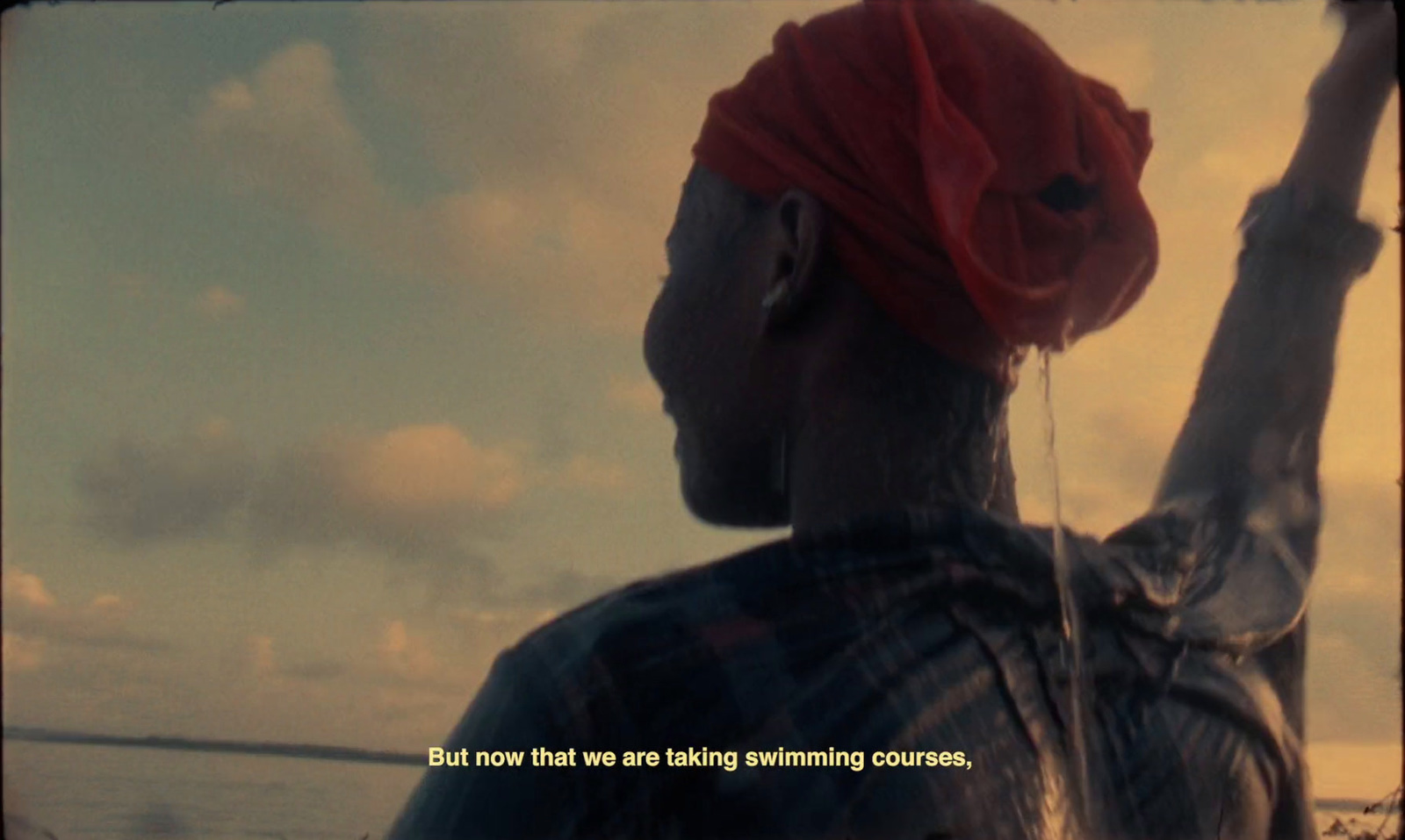 a man with a red turban standing on a boat