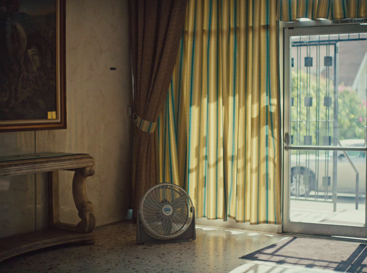 a fan sitting on the floor in front of a window