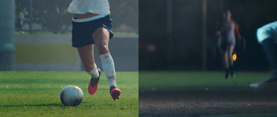 a person kicking a soccer ball on a field