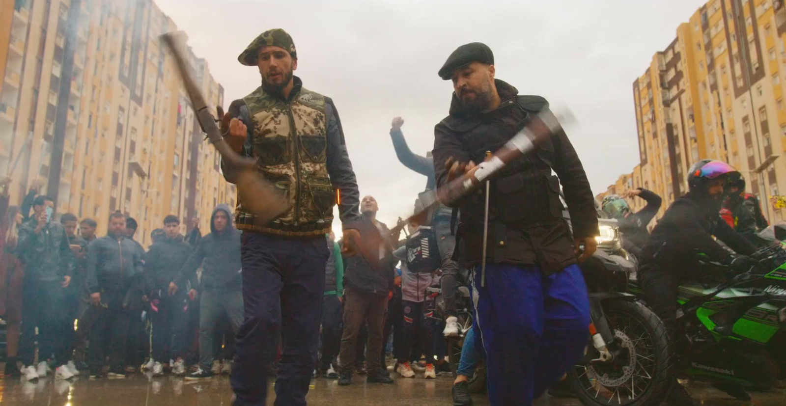 a couple of men standing next to each other on a street