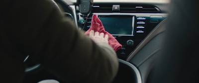 a person cleaning the dashboard of a car