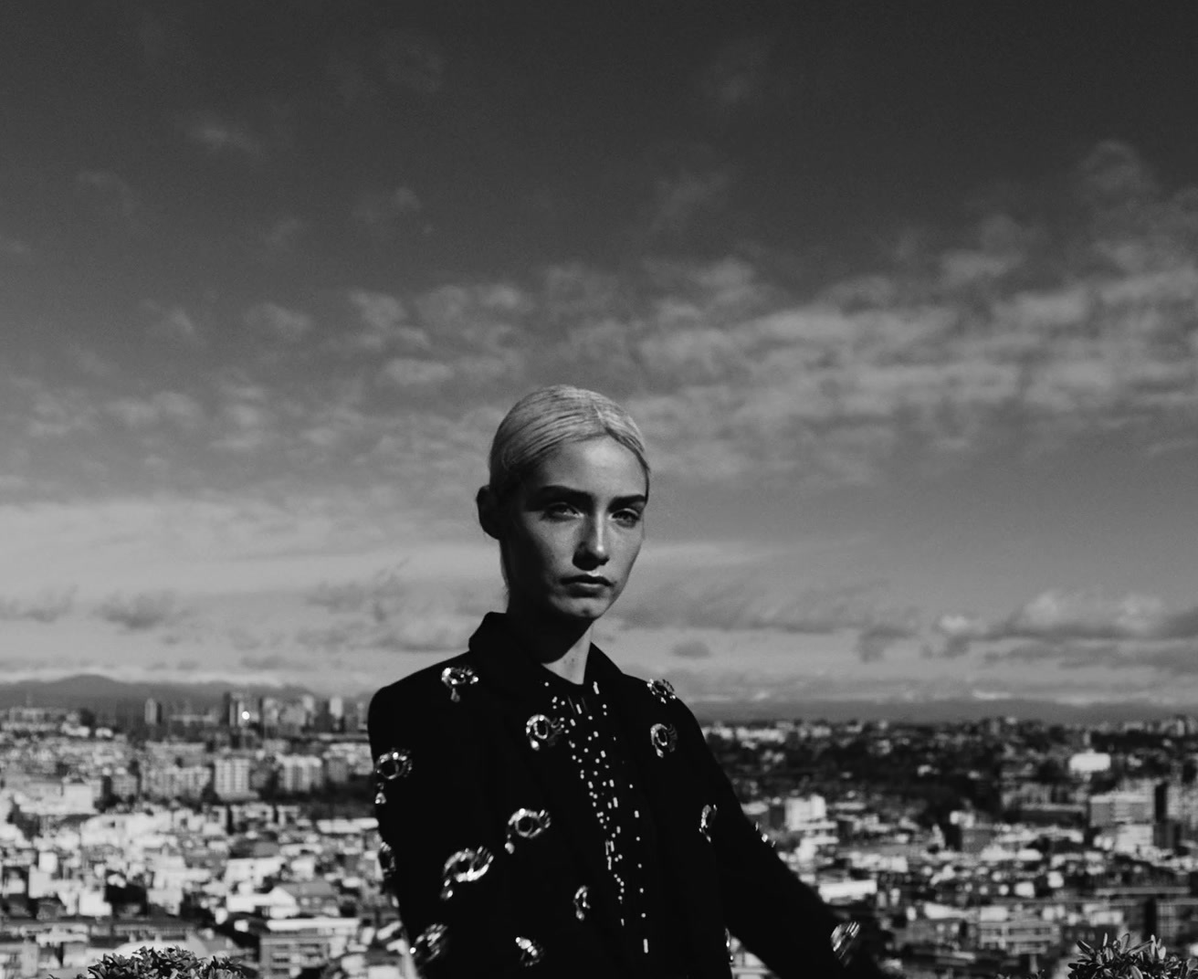 a man standing in front of a cityscape