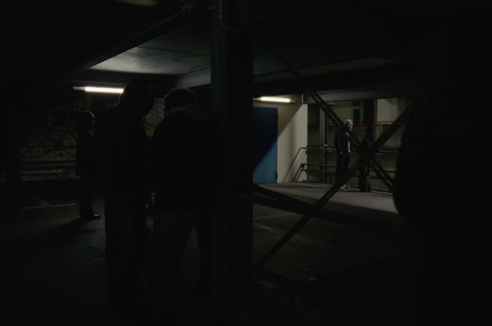 a group of people standing around in the dark