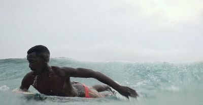 a man riding a wave on top of a surfboard