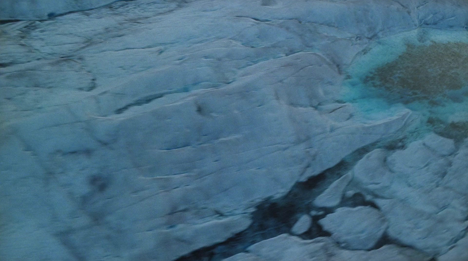 an aerial view of a rock formation with water in it