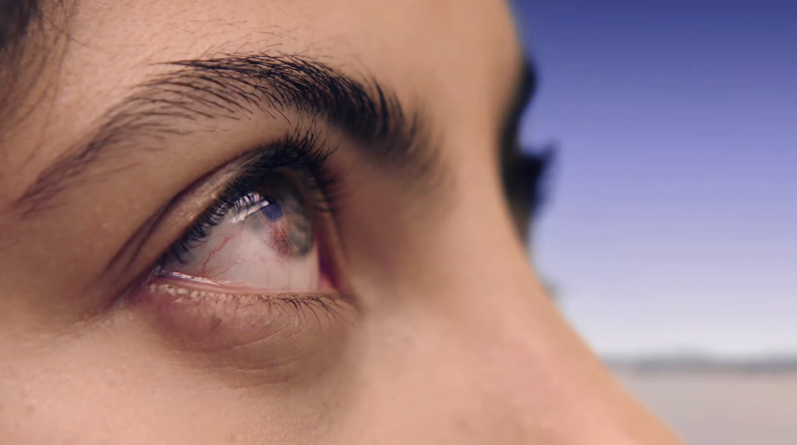 a close up of a person's eye with a blurry background