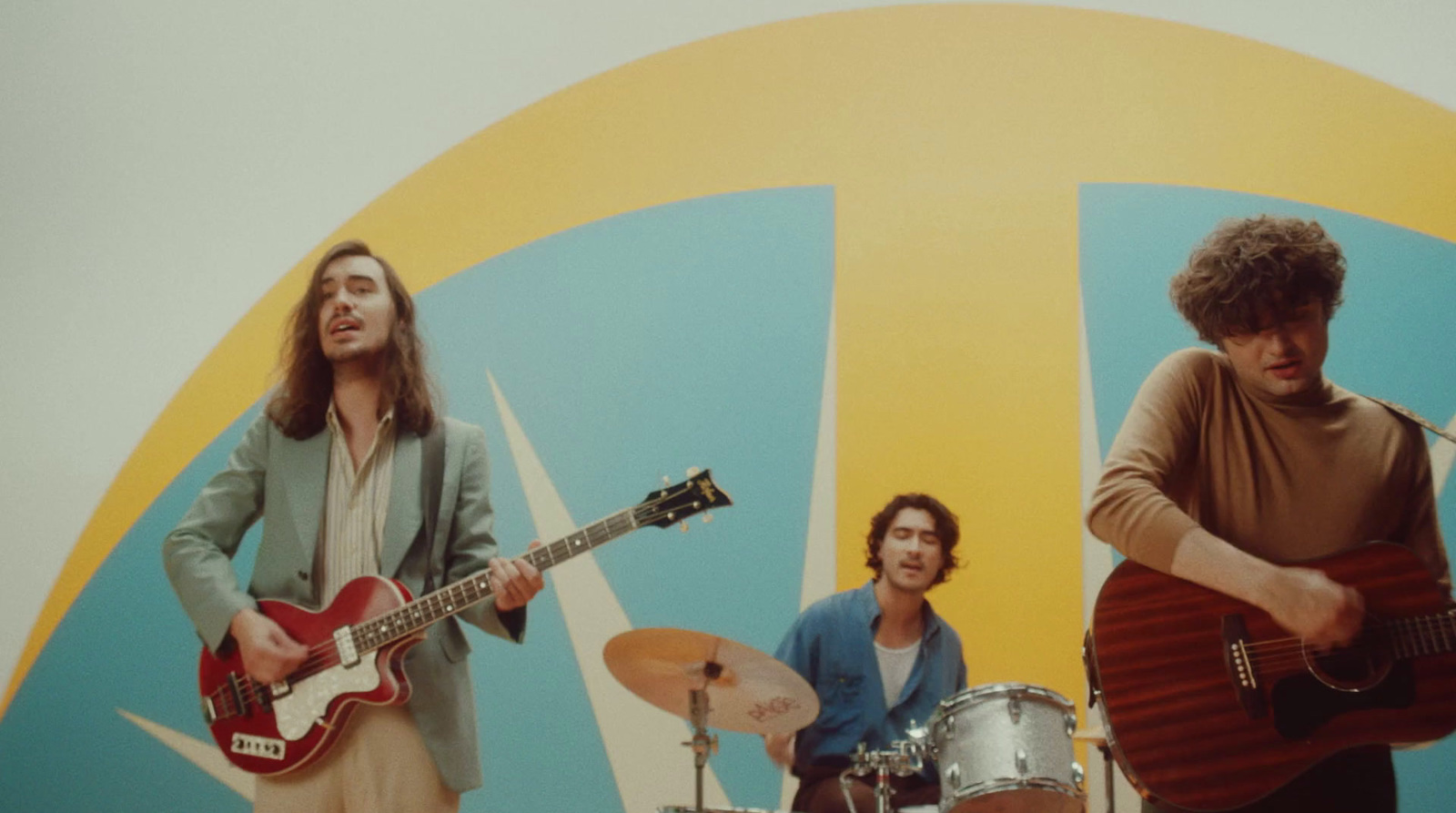 a group of men standing next to each other with guitars