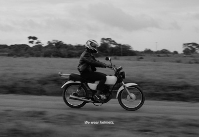 a black and white photo of a person riding a motorcycle