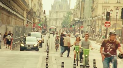 a group of people riding bikes down a street