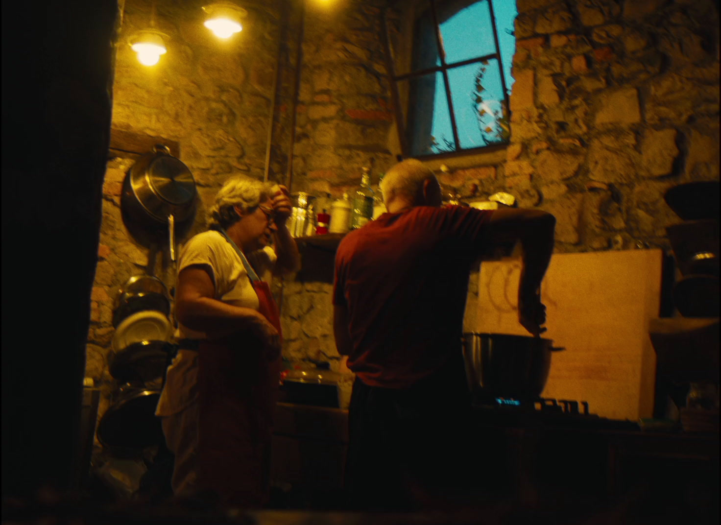 a man and a woman standing in a kitchen