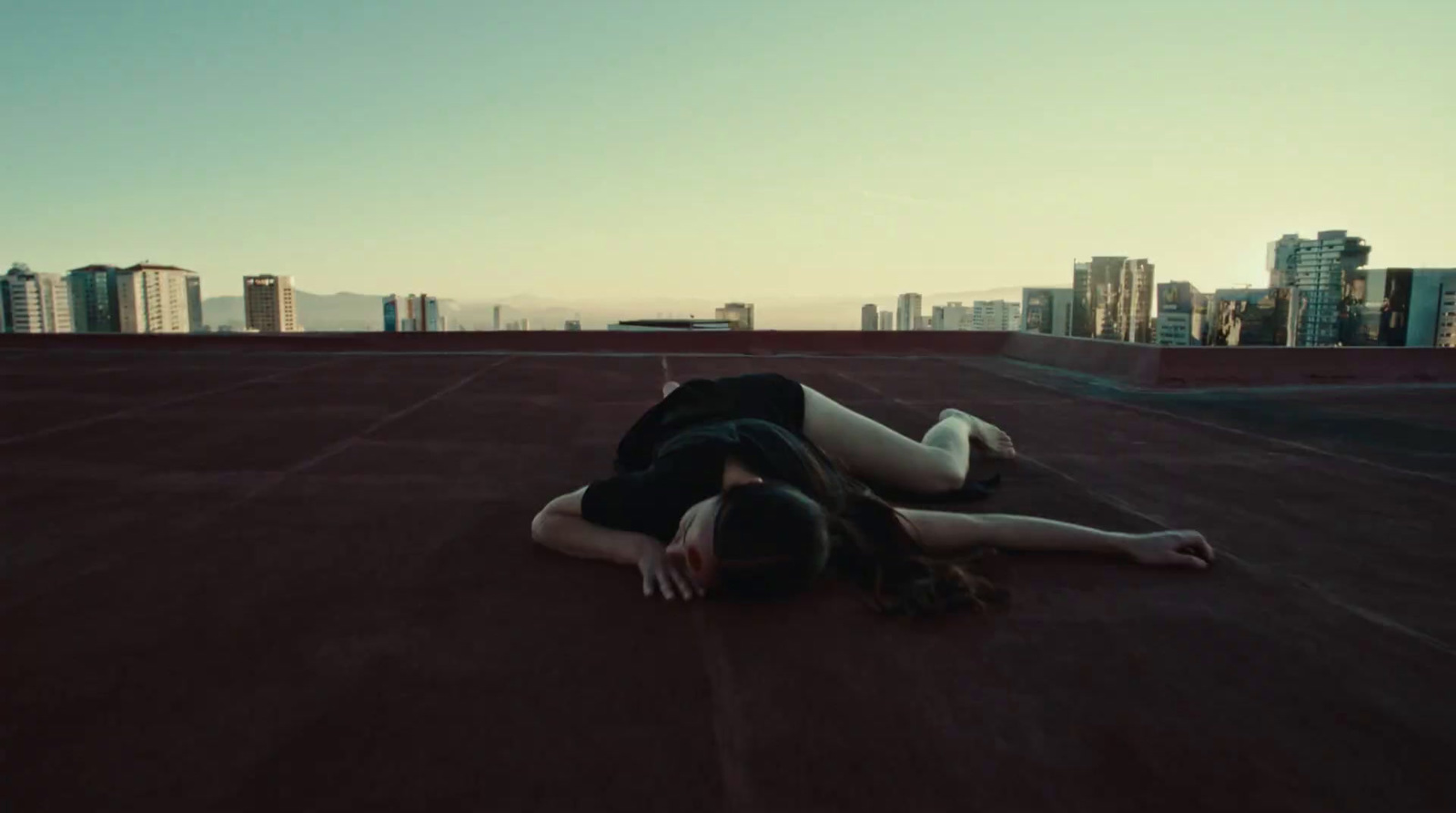 a woman laying on the ground in a city