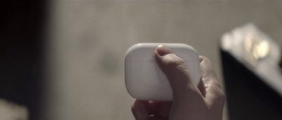 a person holding a white object in their hand