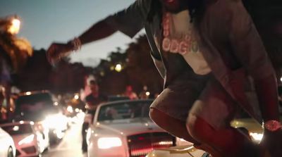 a man riding a skateboard down a busy street