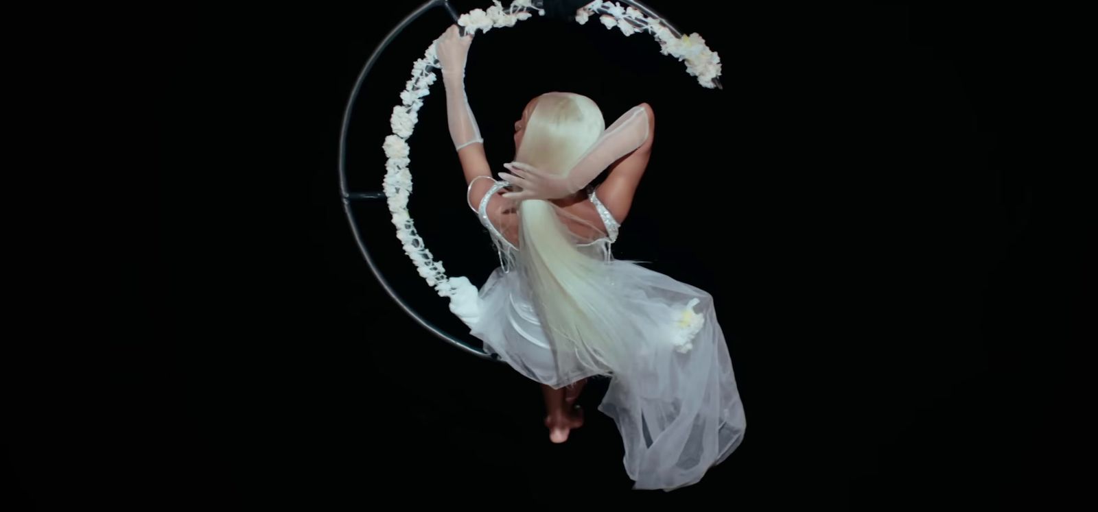 a woman in a white dress flying through the air