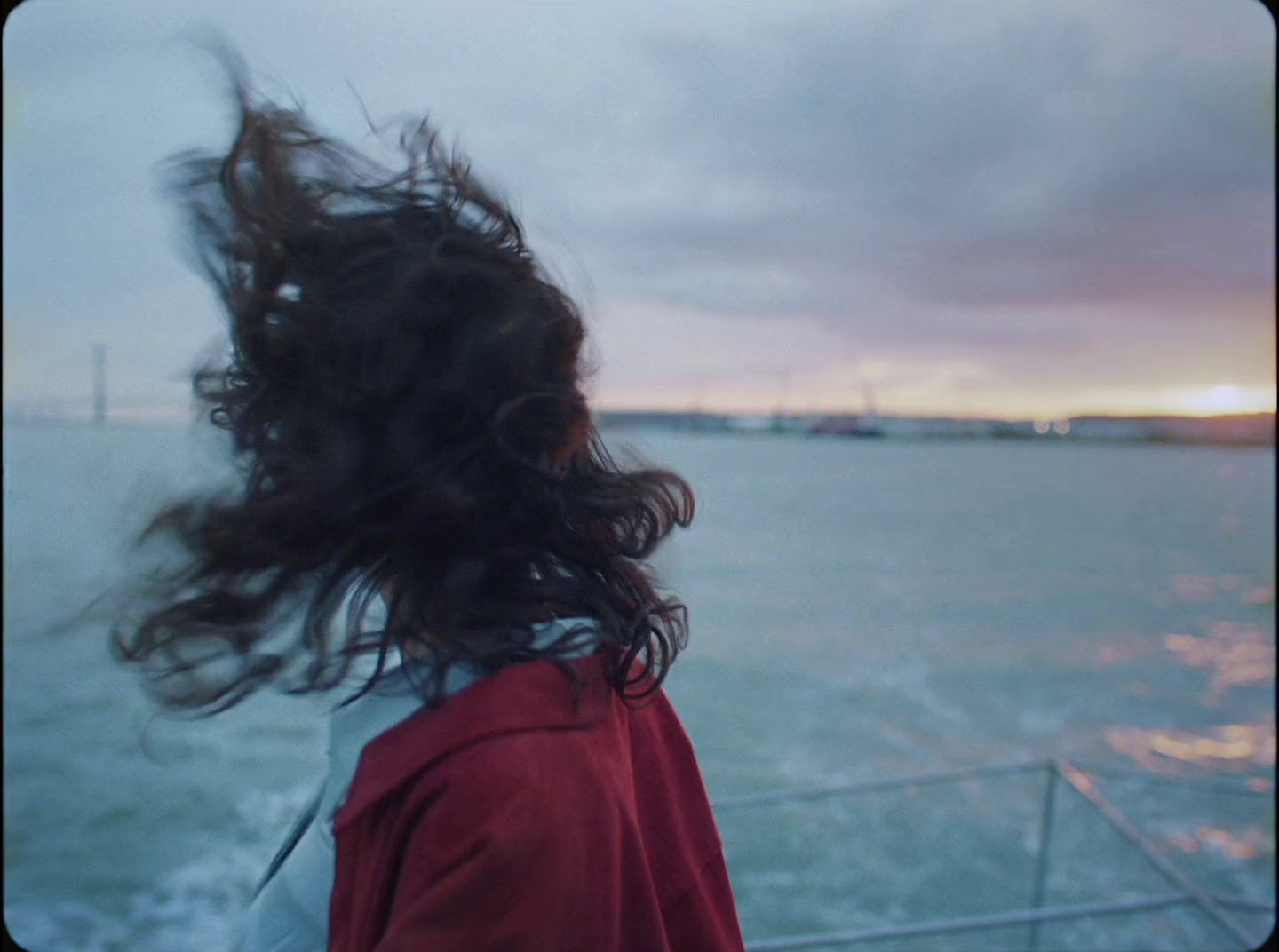 a woman with her hair blowing in the wind