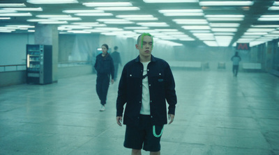 a man in a tie standing in a hallway