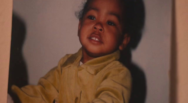 a young child holding a toothbrush in his hand