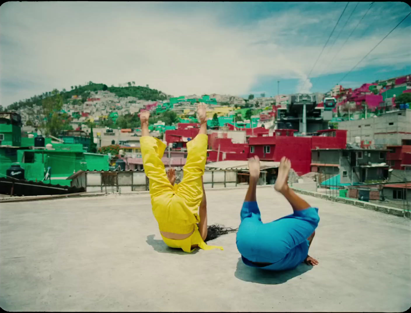 a couple of people laying on top of a roof