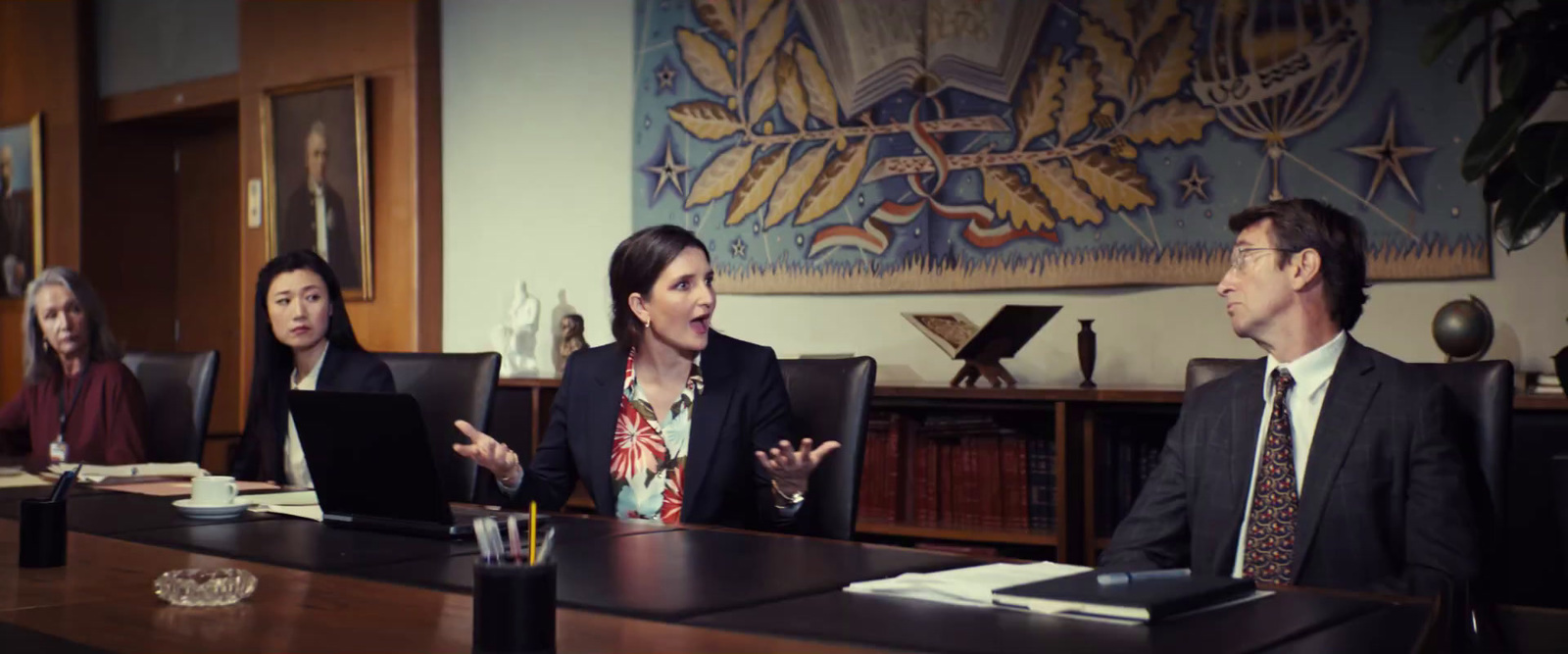 a group of people sitting around a conference table