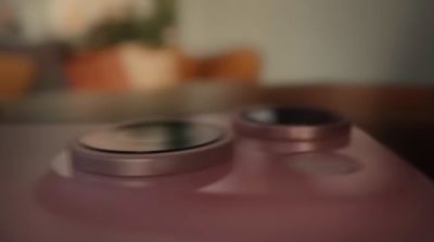 a close up of a pink bottle on a table