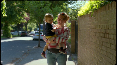 a woman holding a child on the street