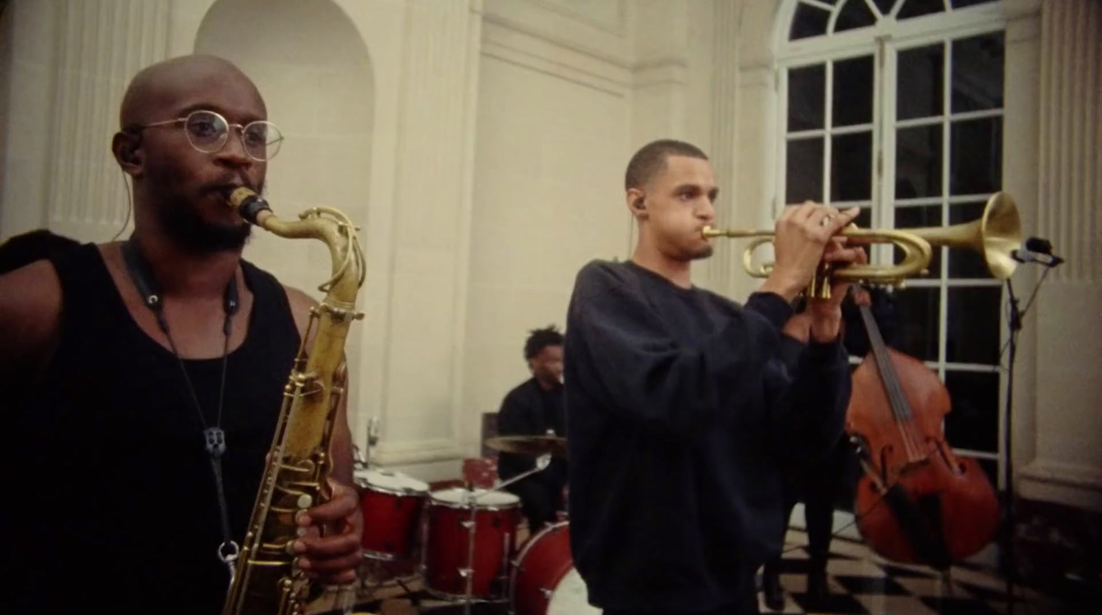 a couple of men playing musical instruments in a room