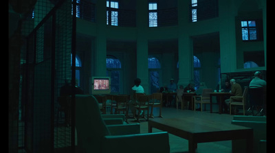 a group of people sitting around a table in a room