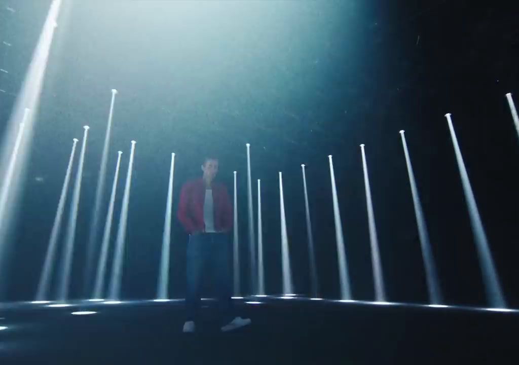 a man standing in front of a row of lights