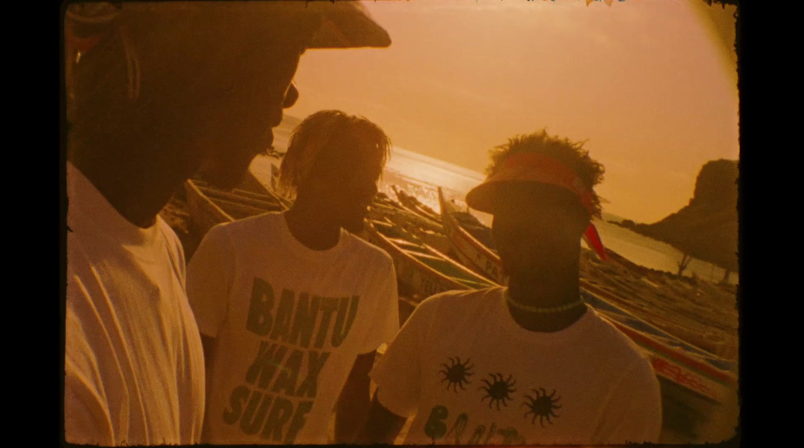 a group of men standing next to each other on a beach