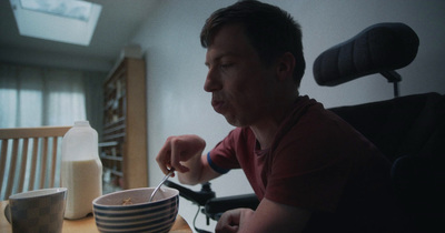 a man sitting at a table with a bowl of food