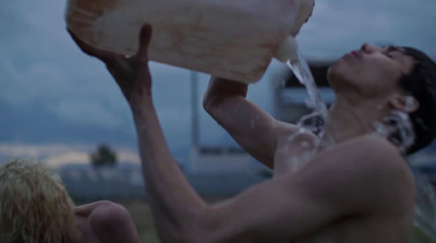 a woman drinking from a bottle of water